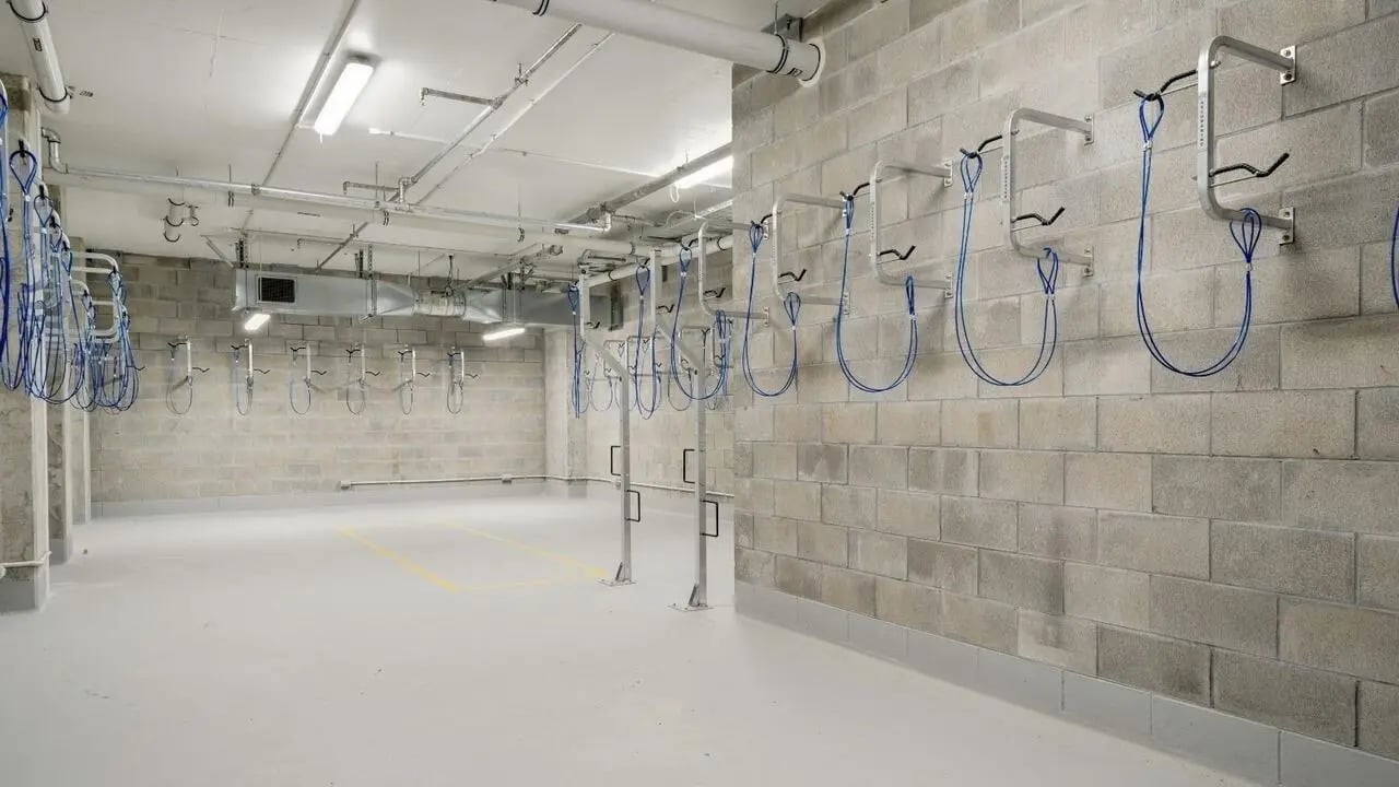 Wall mounted bike racks with blue straps storage area at UniLodge Auckland Central in Auckland Student Accommodation