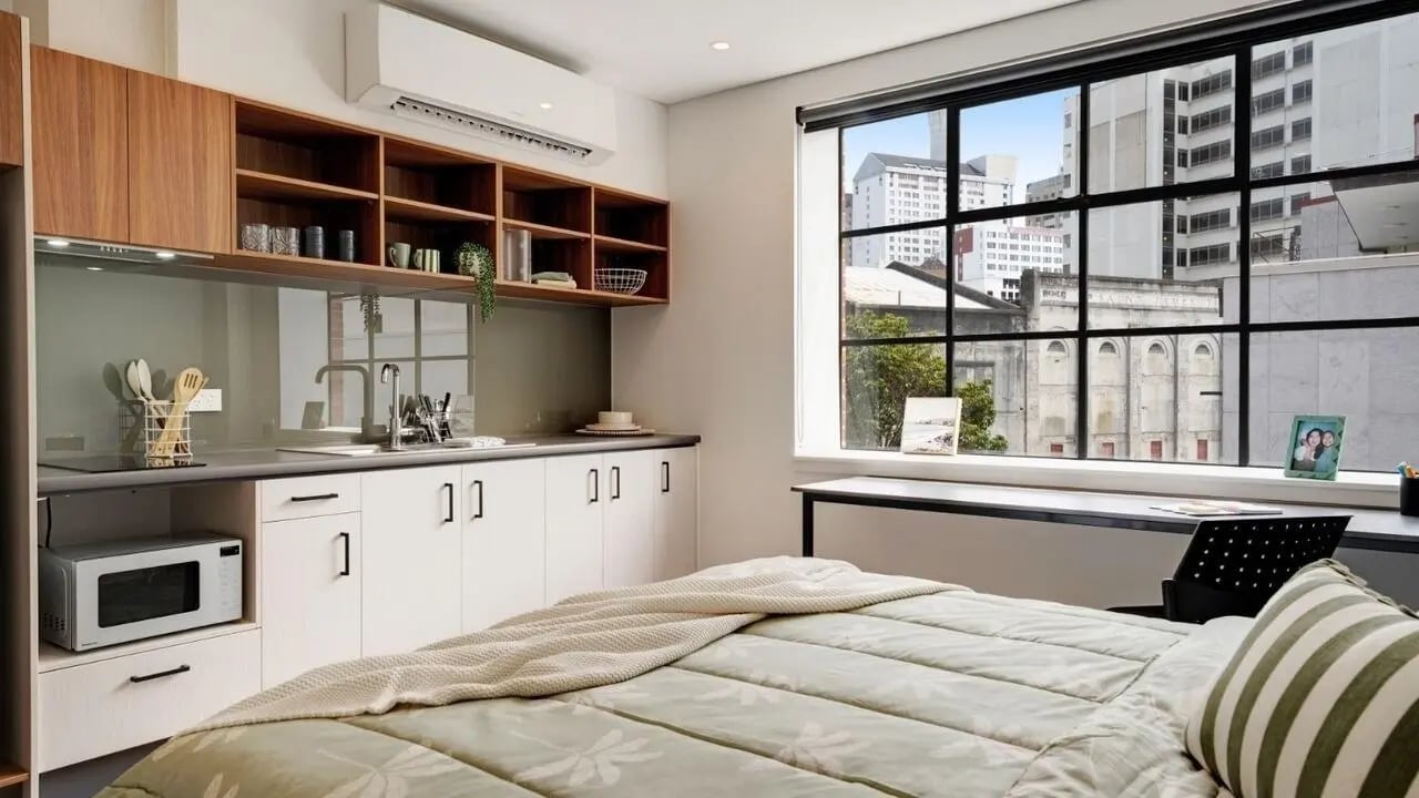 Bed with kitchen and desk view bedroom at UniLodge Auckland Central in Auckland Student Accommodation