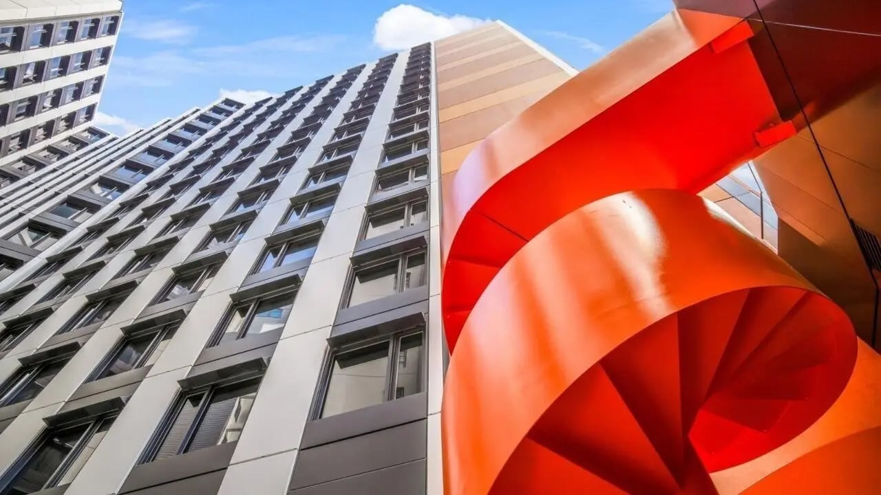 Modern building with orange spiral staircase exterior at UniLodge Auckland Central in Auckland Student Accommodation