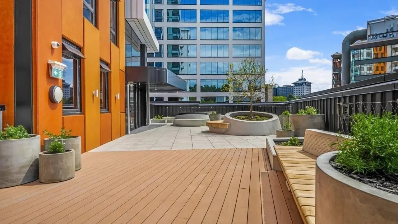 Outdoor terrace with concrete planters and wooden seating outdoor area at UniLodge Auckland Central in Auckland Student Accommodation