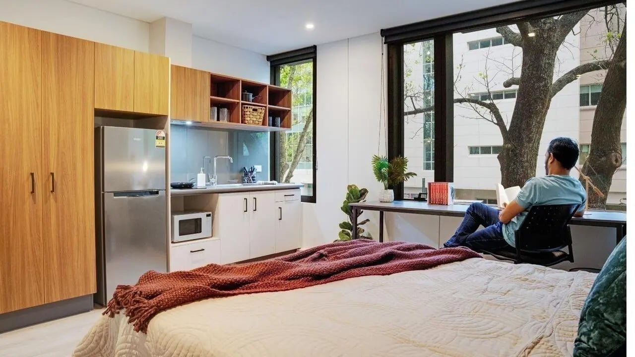 Bed wardrobe microwave kitchen area study room exterior at UniLodge Auckland Central in Auckland Student Accommodation