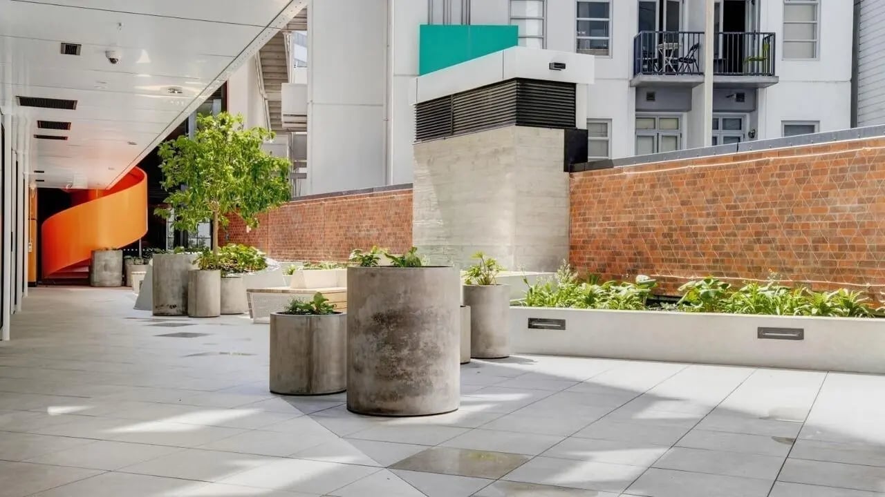 Concrete planters orange spiral staircase exterior at UniLodge Auckland Central in Auckland Student Accommodation