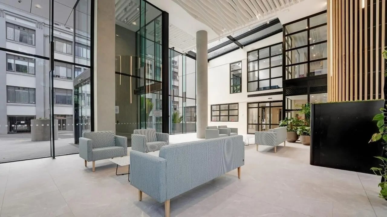 Modern reception area with sofas chairs and plants lobby at UniLodge Auckland Central in Auckland Student Accommodation