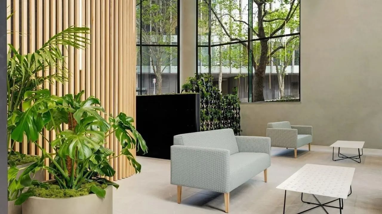 Sofa chairs coffee tables plants living room at UniLodge Auckland Central in Auckland Student Accommodation