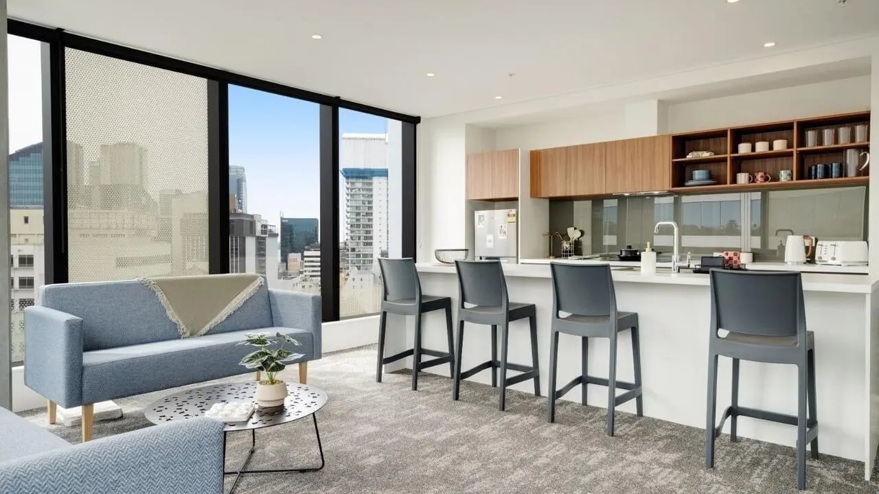 Sofa bar stools and kitchen counter Living room at UniLodge Auckland Central in Auckland Student Accommodation