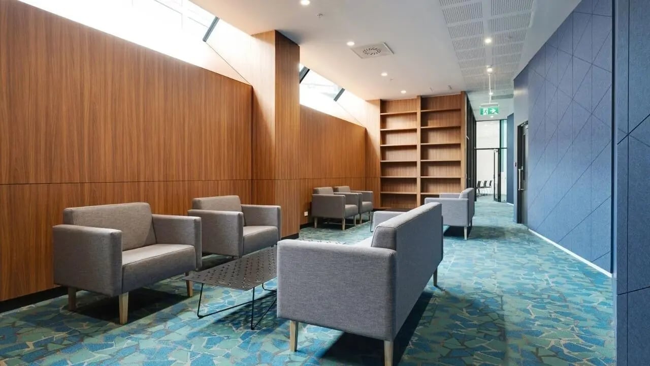 Grey sofas and bookshelves in a communal area at UniLodge Auckland Central in Auckland Student Accommodation