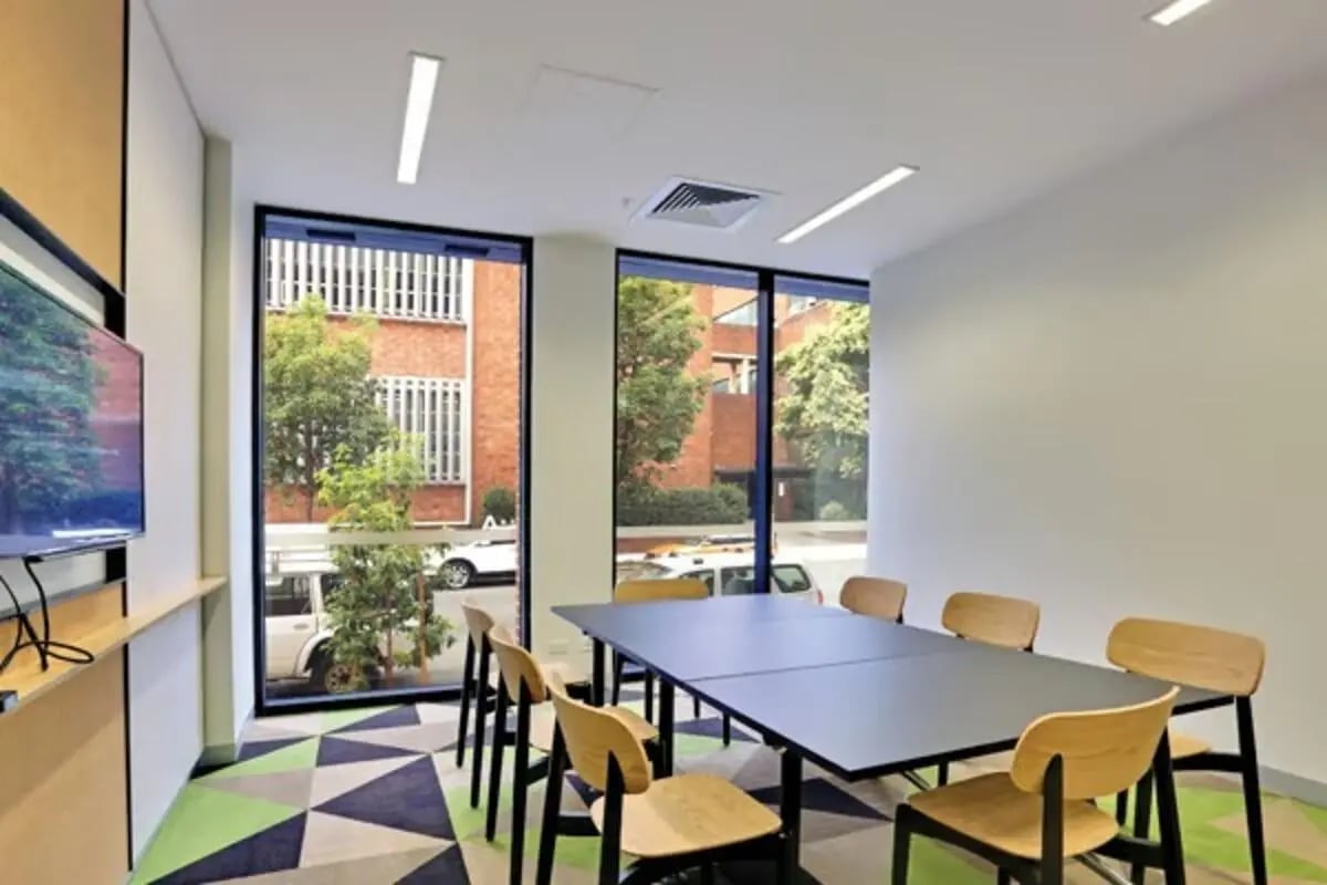 Meeting table with chairs and TV area at Scape Sydney Central in Sydney Student Accommodation