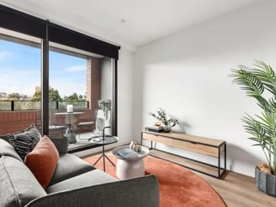 Sofa balcony table cabinet plant rug living room at Caulfield Place in Melbourne Student Accommodation