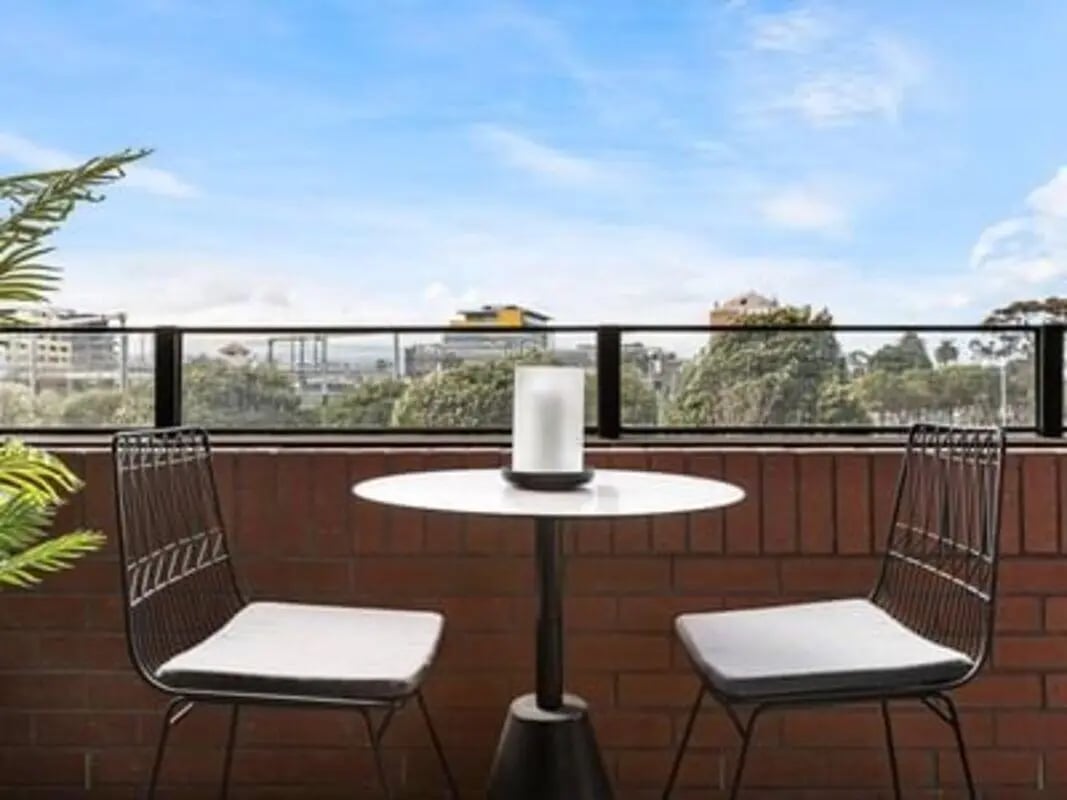 Two chairs table lamp balcony exterior at Caulfield Place in Melbourne Student Accommodation