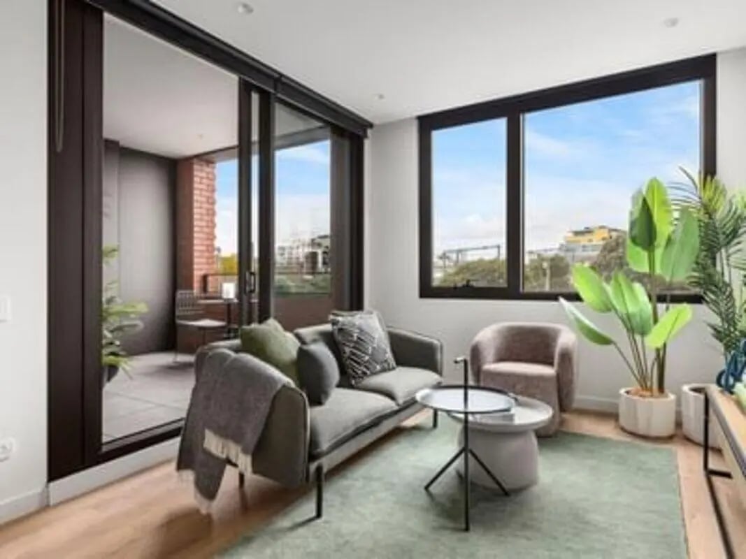 Sofa chairs coffee table plants living room at Caulfield Place in Melbourne Student Accommodation