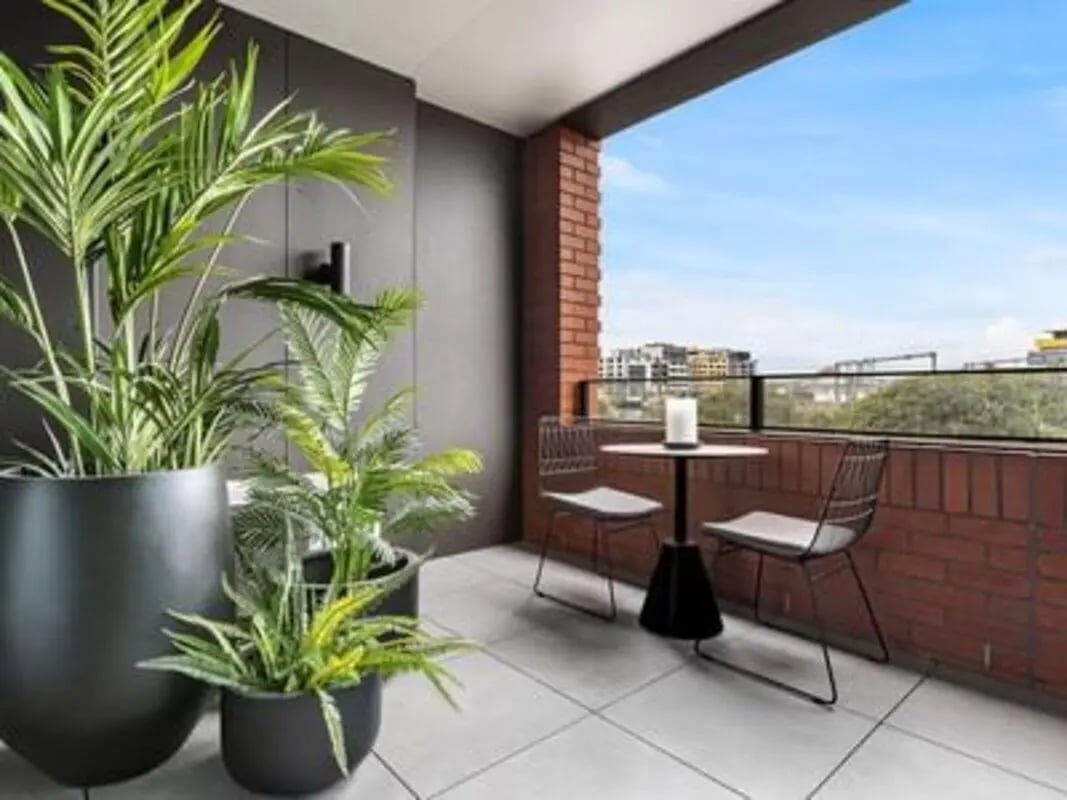 Plants table chairs on balcony exterior at Caulfield Place in Melbourne Student Accommodation