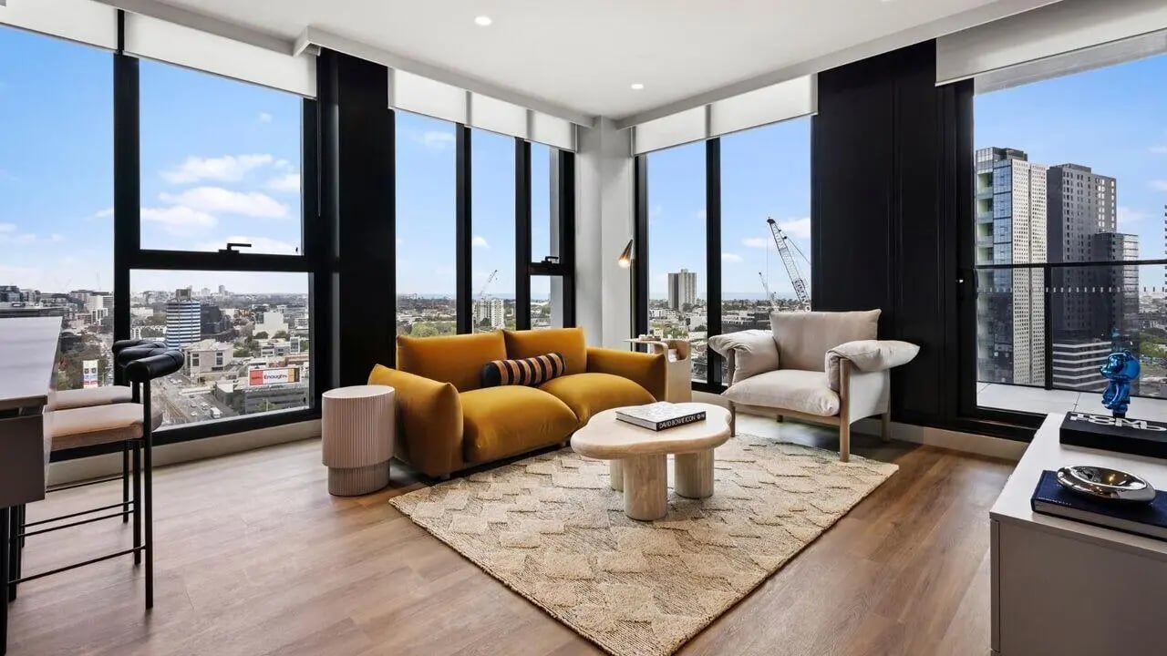 Yellow sofa armchair coffee table rug living room at Indi South Bank in Melbourne Student Accommodation