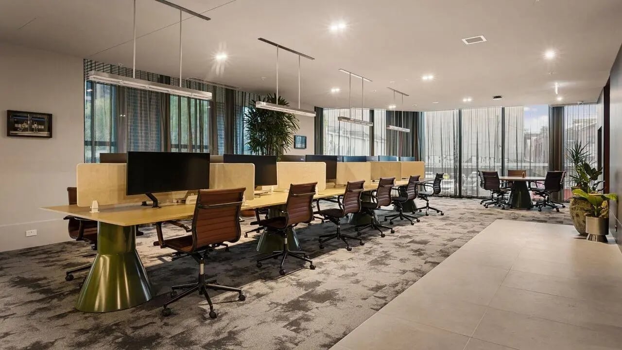 Desks chairs and monitors study area at Indi South Bank in Melbourne Student Accommodation