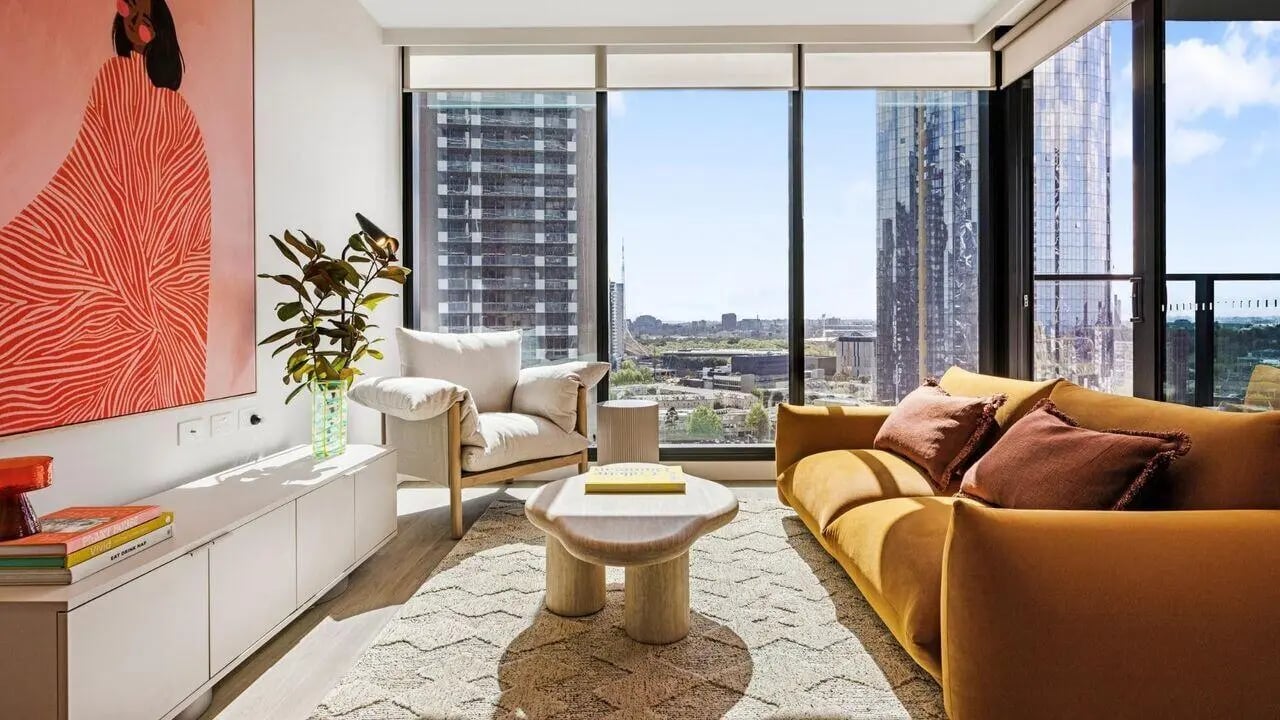 Modern living room with artwork sofa armchair living room at Indi South Bank in Melbourne Student Accommodation