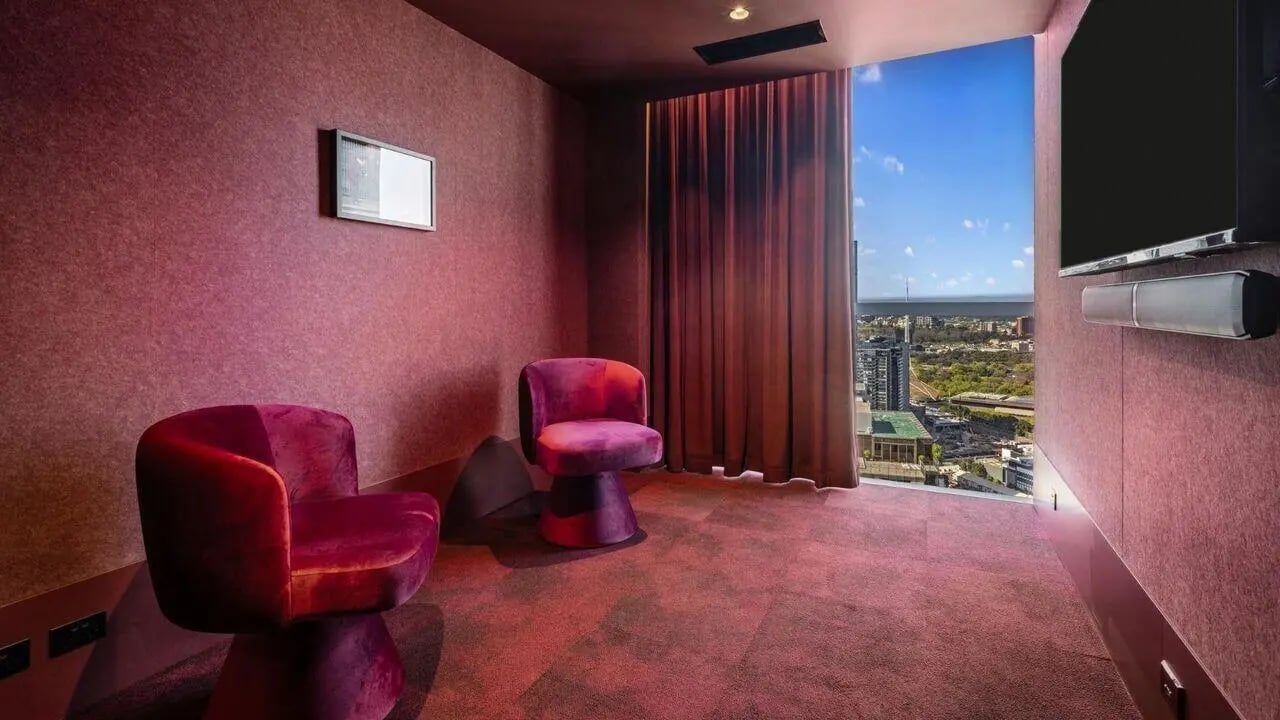 Two plush chairs and TV lounge area at Indi South Bank in Melbourne Student Accommodation