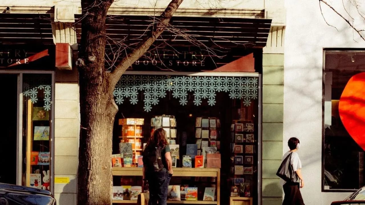 Bookstore storefront with books and people exterior at The Archive - Residential Living in Melbourne Student Accommodation