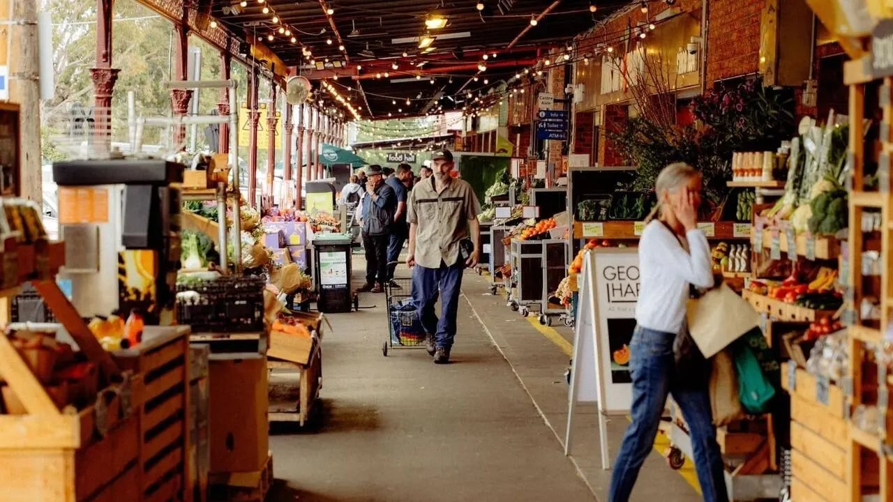 Market stalls people and produce exterior at The Archive - Residential Living in Melbourne Student Accommodation