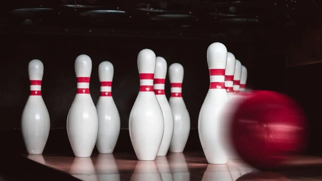 White bowling pins with red stripes and red ball bowling area at West Tower, Melbourne Quarter in Melbourne Student Accommodation