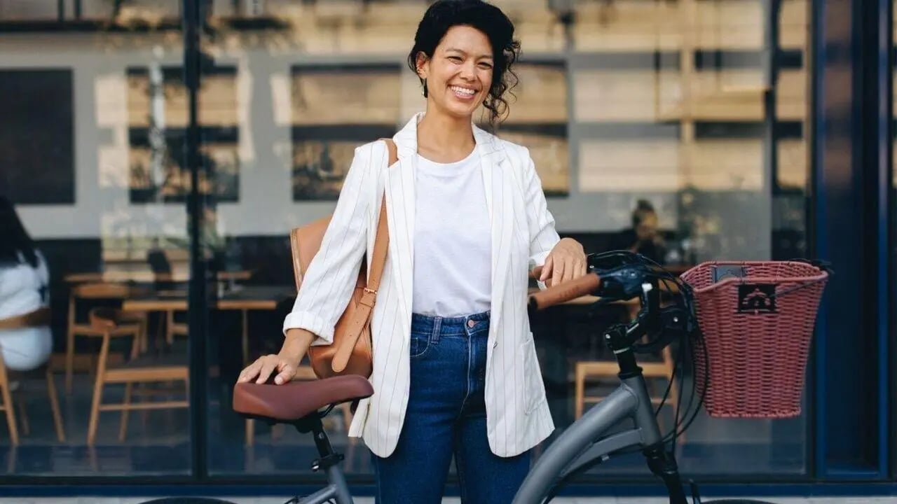 Woman with bicycle outside cafe exterior at West Tower, Melbourne Quarter in Melbourne Student Accommodation