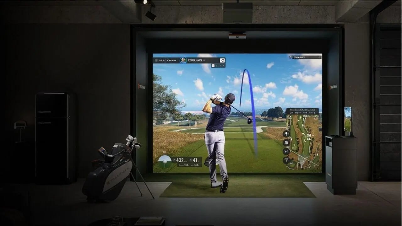 Golf simulator with player golf clubs and a fridge interior at West Tower, Melbourne Quarter in Melbourne Student Accommodation