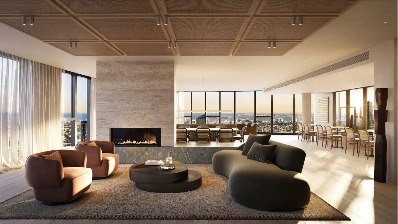 Stylish living room with fireplace and dining area at West Tower, Melbourne Quarter in Melbourne Student Accommodation