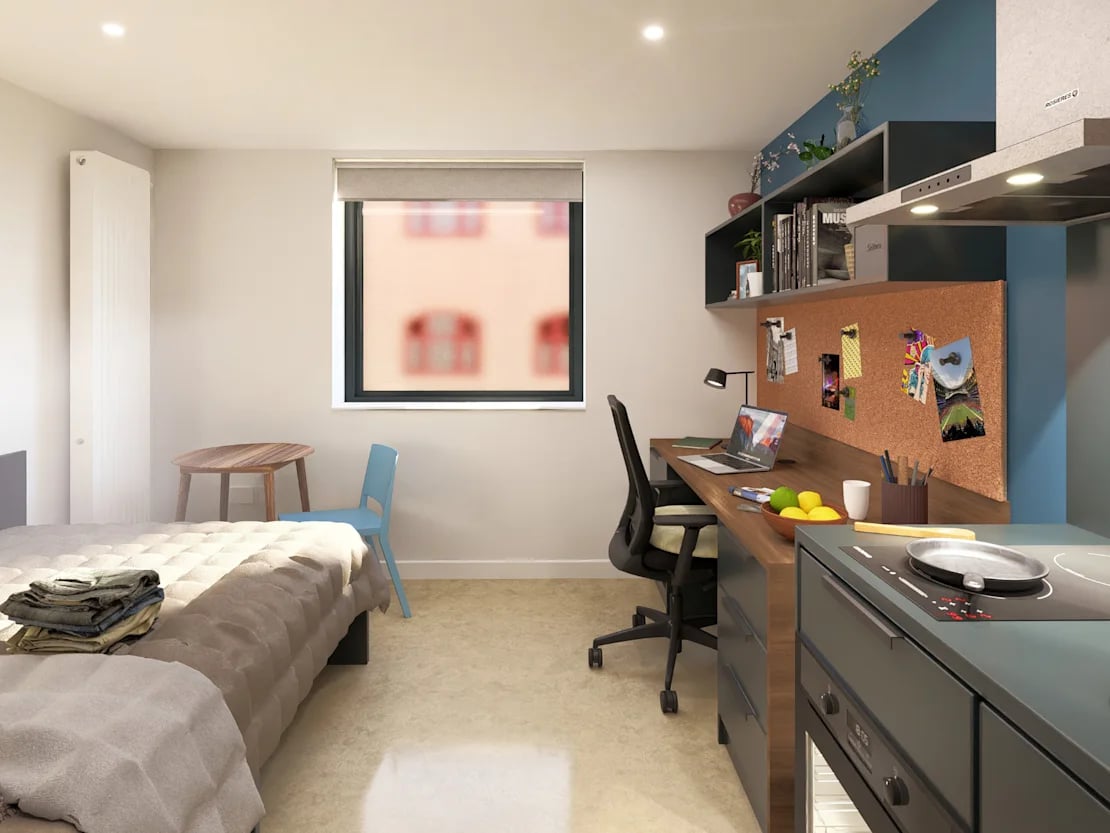 Bed desk chair kitchen area and window bedroom at Croft Court in Bristol Student Accommodation