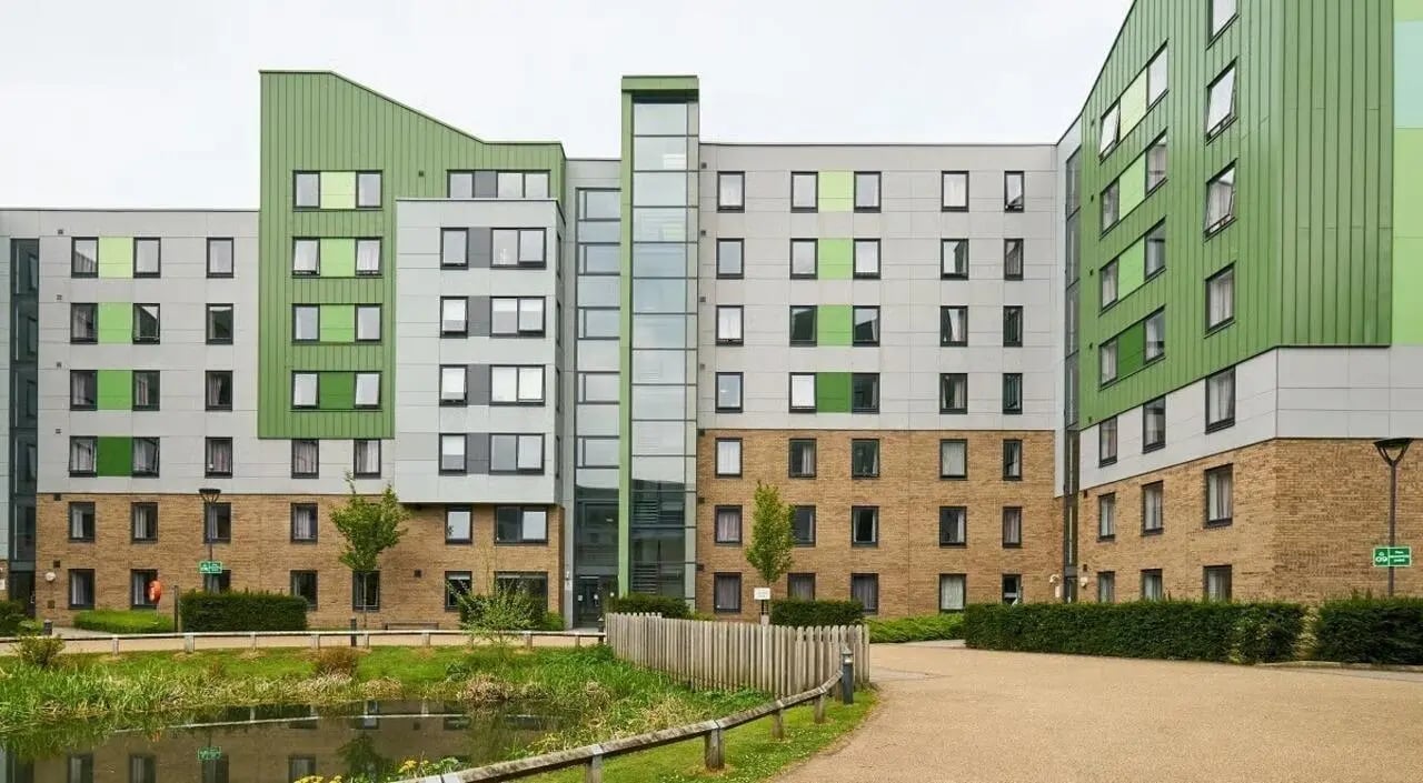 Modern student accommodation building exterior with pond exterior at The Green in Bradford Student Accommodation