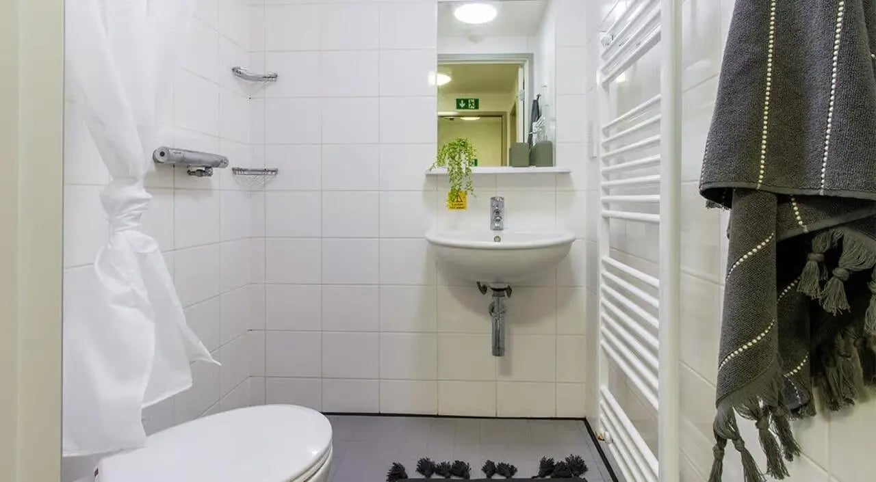 Toilet sink shower curtain towel rack bathroom at The Green in Bradford Student Accommodation