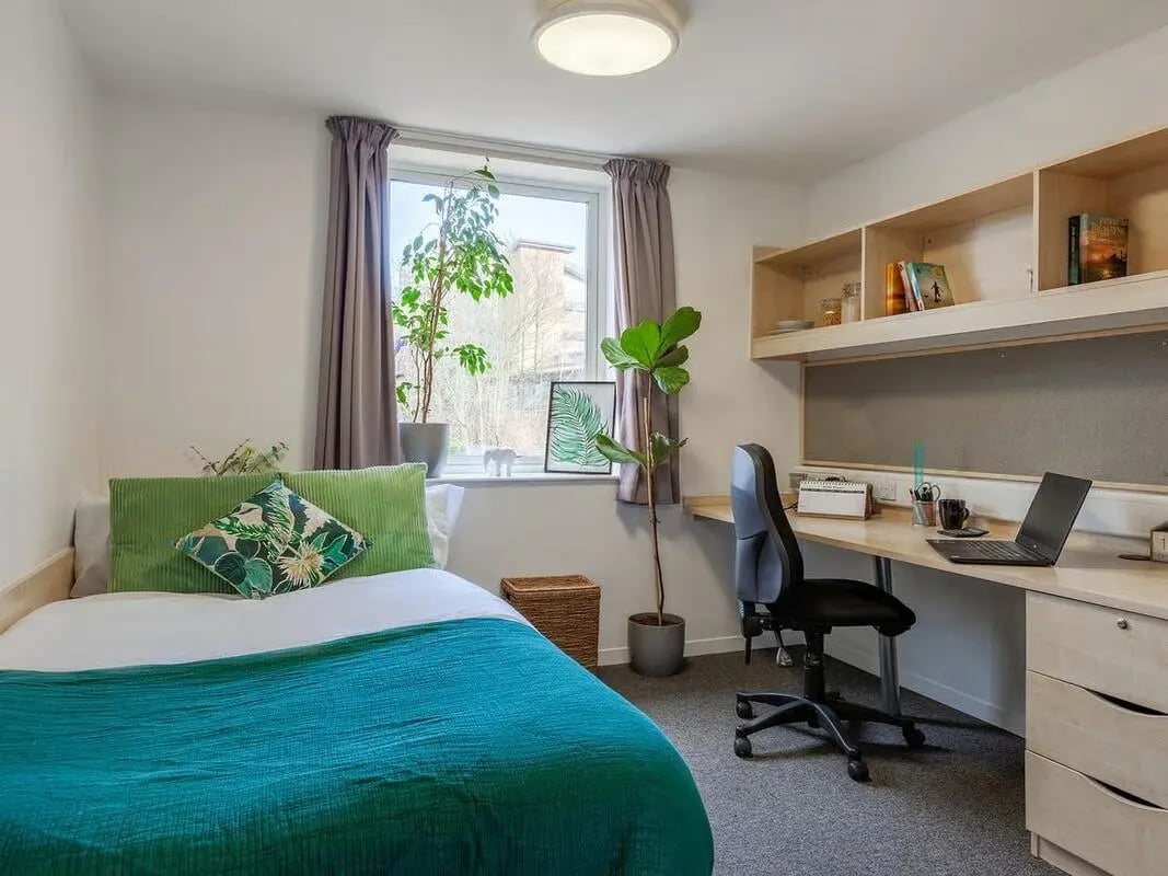 Bed desk chair and shelves student room at The Green in Bradford Student Accommodation