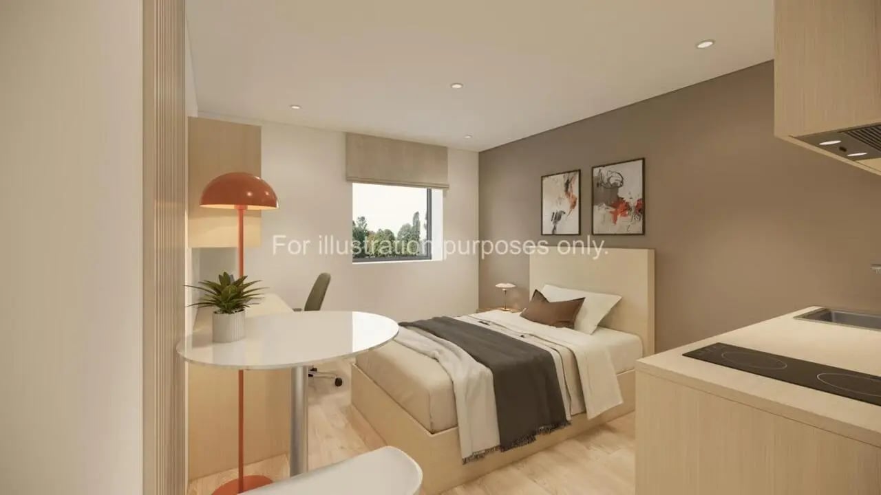 Bed desk lamp paintings and kitchen area bedroom at Stellaris in Cambridge Student Accommodation