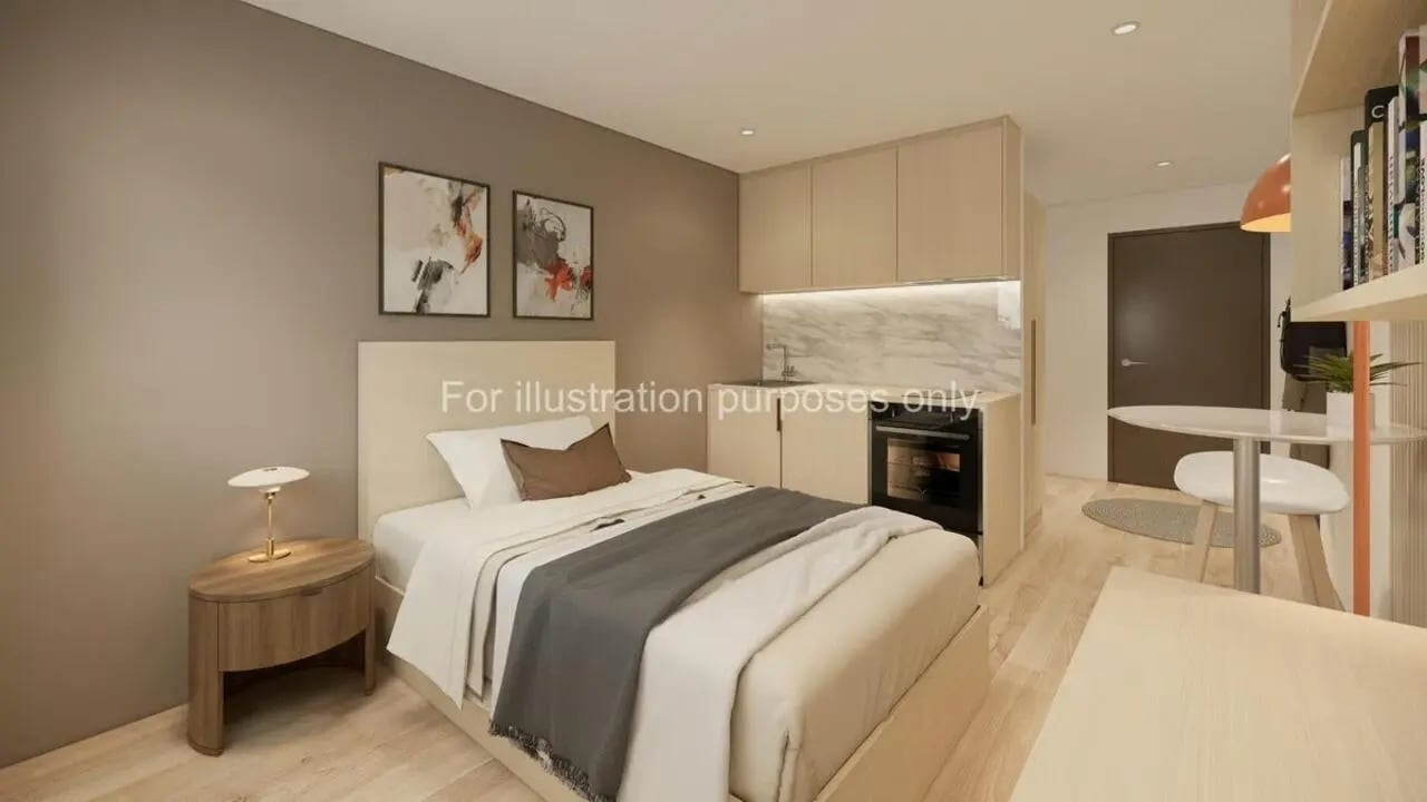 Bed with side table and kitchenette studio apartment at Stellaris in Cambridge Student Accommodation