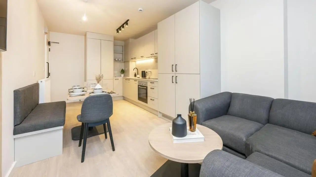 Sofa kitchen dining area living room kitchen at Press House in London Student Accommodation