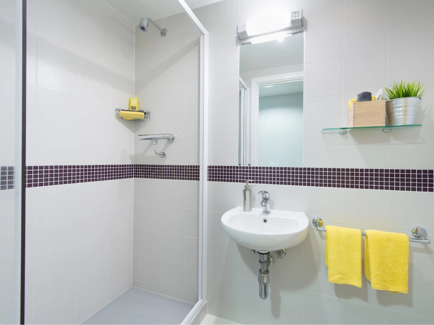 Shower sink towels and mirror bathroom at Glassyard Building in London Student Accommodation