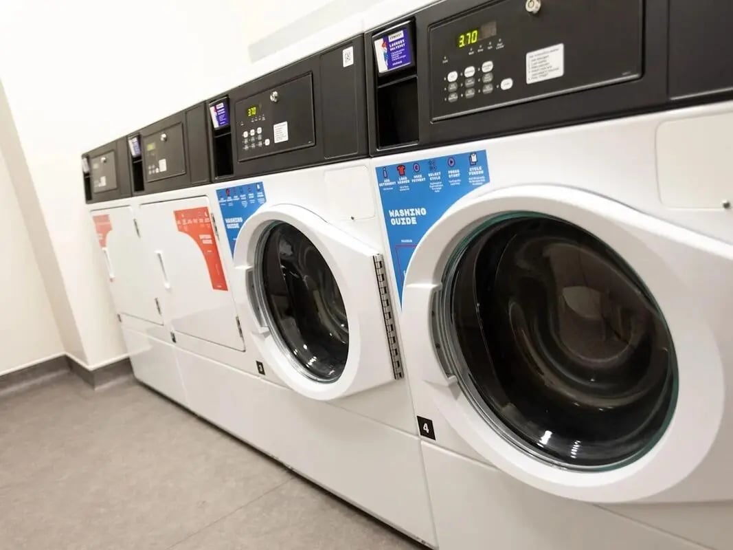 Row of white washing machines laundry area at Stanley Studios - Portsmouth in Portsmouth Student Accommodation