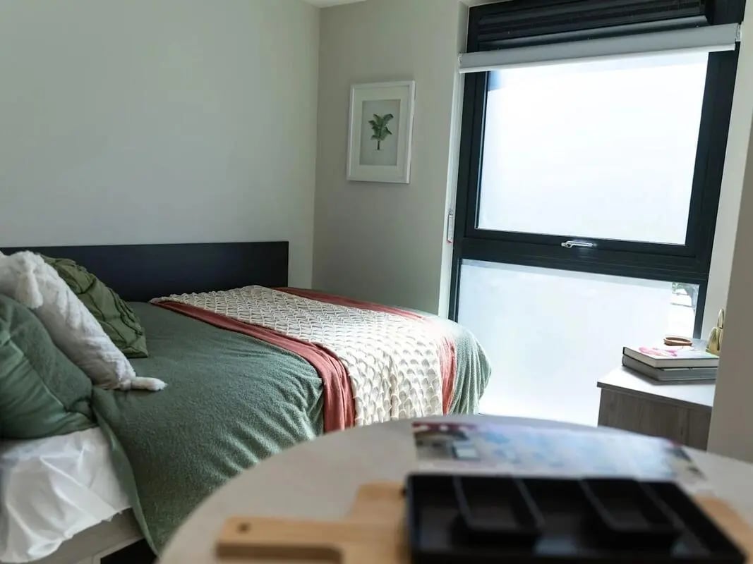 Bed with green bedding and pillows bedroom at Stanley Studios - Portsmouth in Portsmouth Student Accommodation