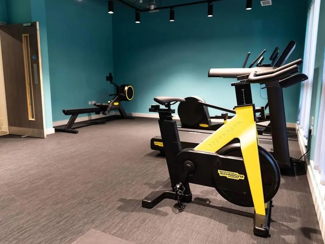 Gym equipment includes spin bike and rower playing area at Stanley Studios - Portsmouth in Portsmouth Student Accommodation