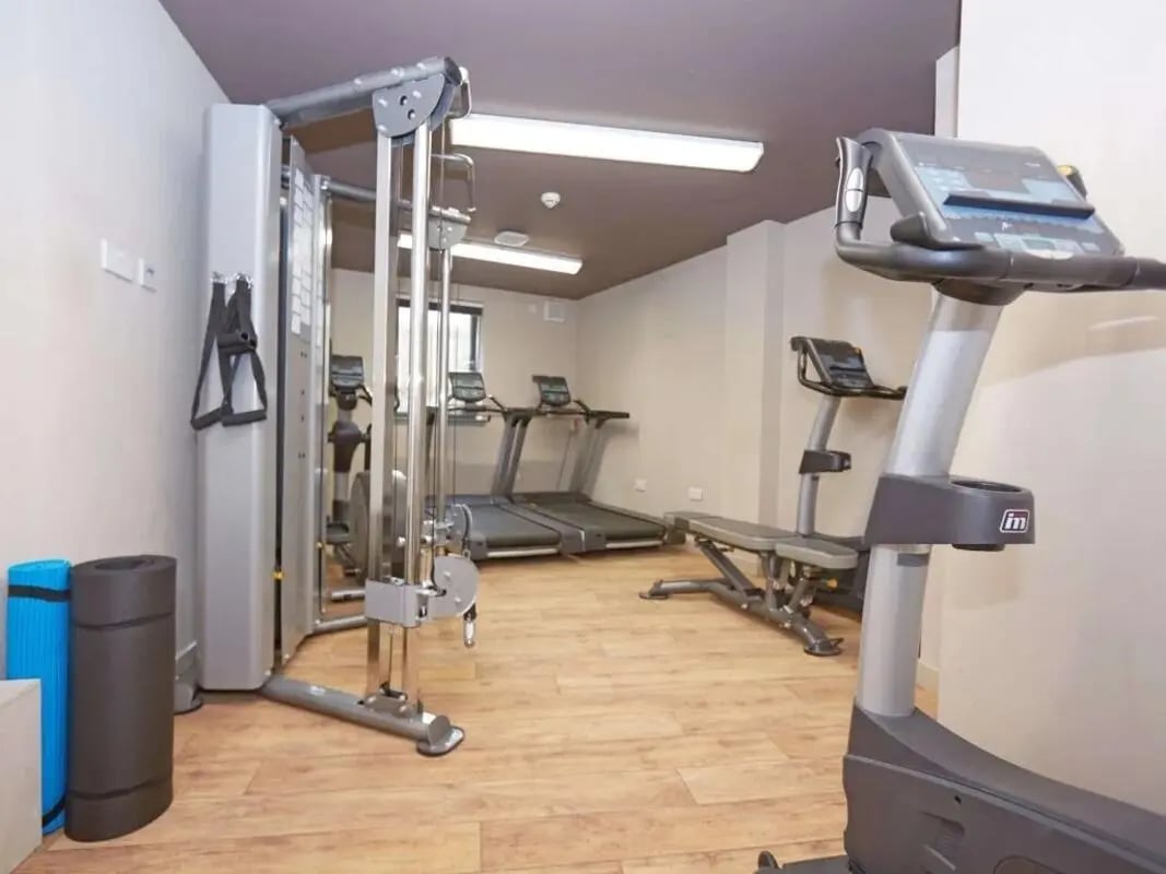 Gym equipment treadmills weight machine bench fitness room at Woodside House in Glasgow Student Accommodation