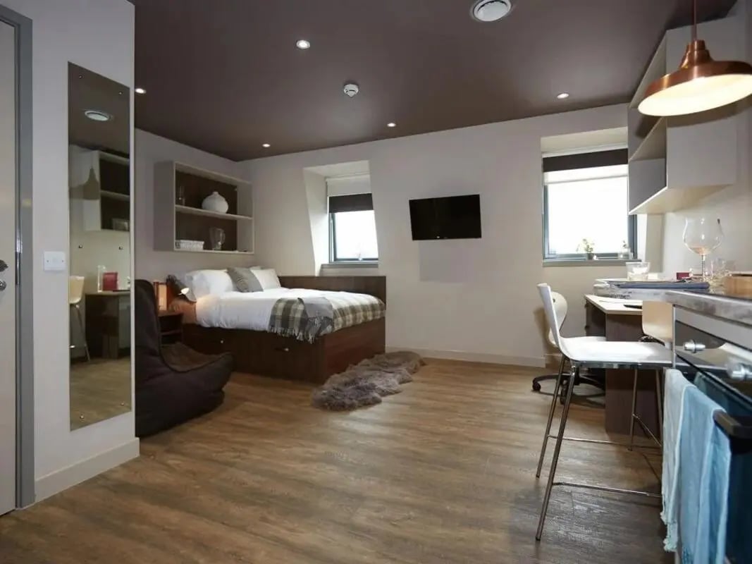 Bed desk TV and kitchen area student studio at Woodside House in Glasgow Student Accommodation