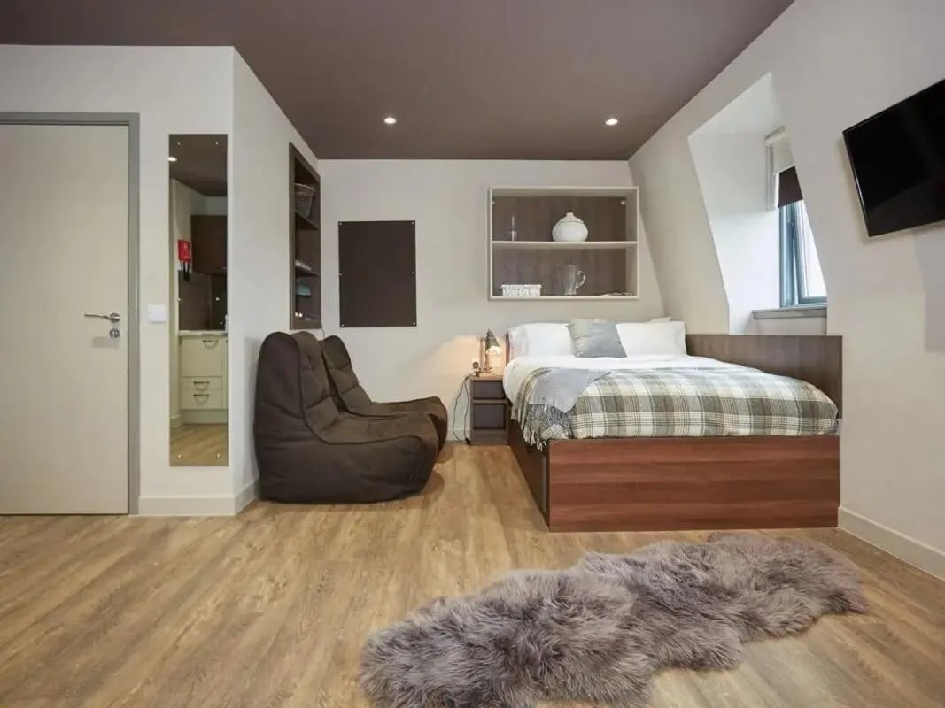 Bed beanbags rug shelves and television Bedroom at Woodside House in Glasgow Student Accommodation
