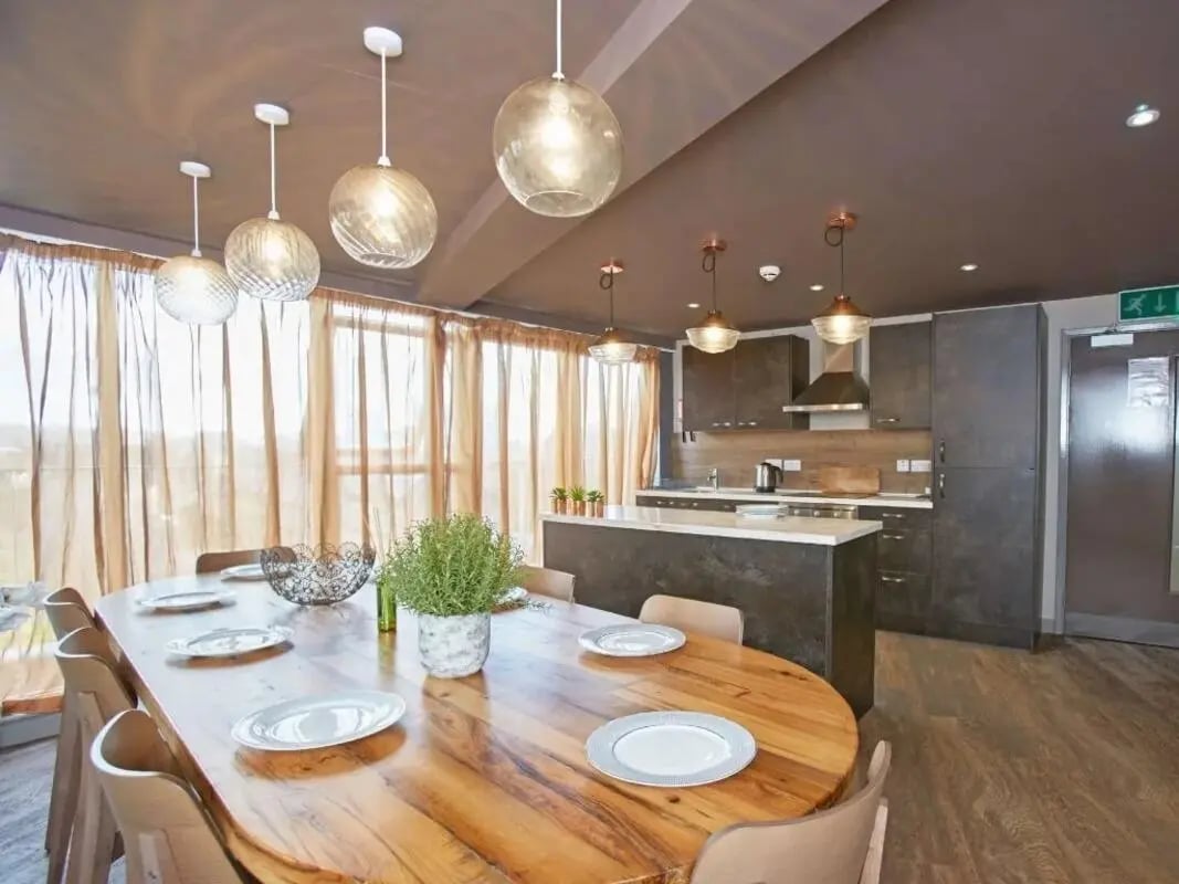 Wooden dining table with chairs kitchen area Image Type at Woodside House in Glasgow Student Accommodation