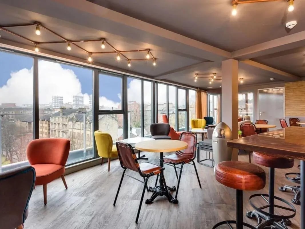 Colorful chairs tables and bar stools lounge area at Woodside House in Glasgow Student Accommodation