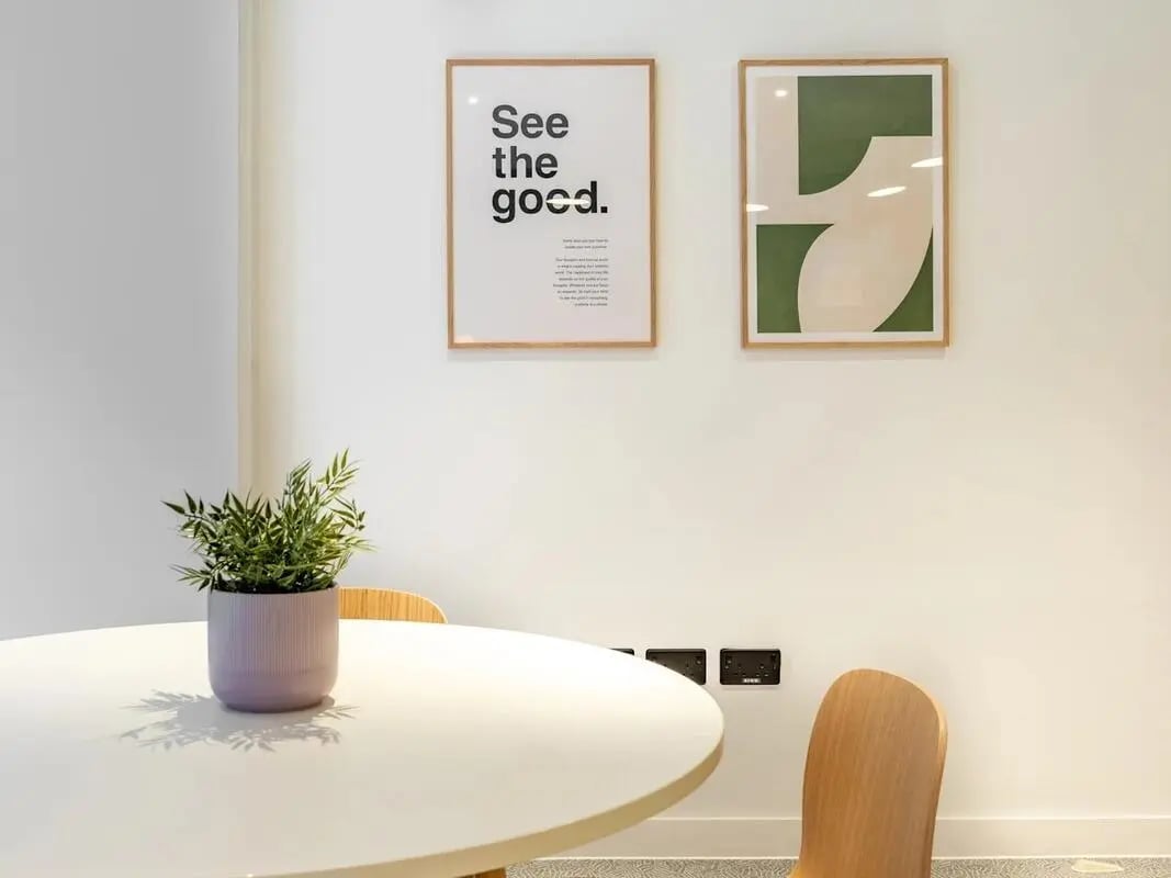 Round white table with potted plant and chairs living room at Glassworks in Bristol Student Accommodation