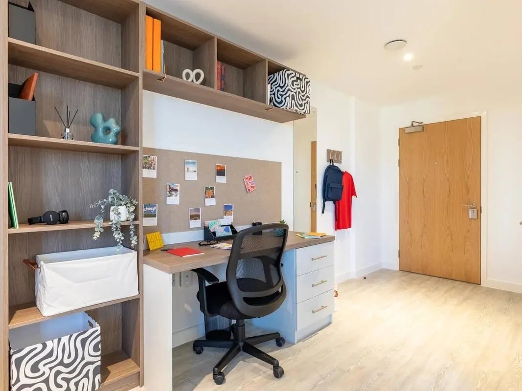 Desk chair shelves corkboard backpack and door study area at Glassworks in Bristol Student Accommodation