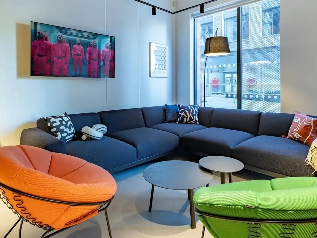 Sofa, chairs, tables, television, artwork living room at Glassworks in Bristol Student Accommodation