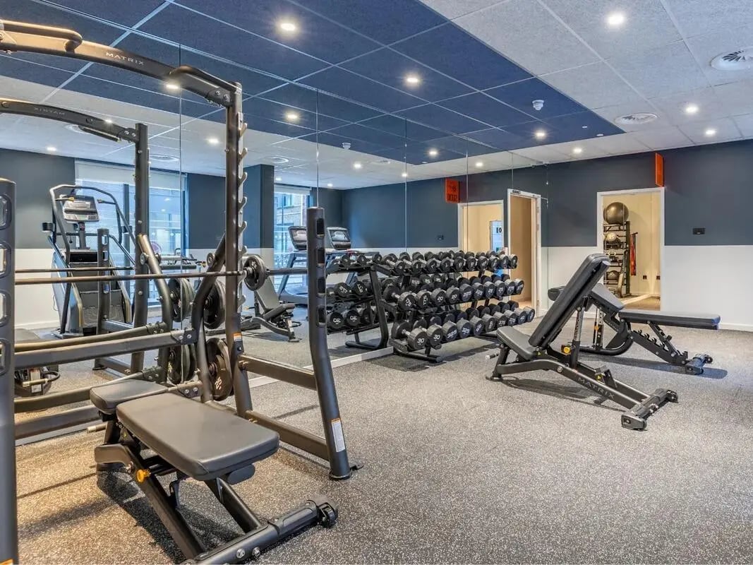 Dumbbell rack weight benches treadmills gym area at Glassworks in Bristol Student Accommodation