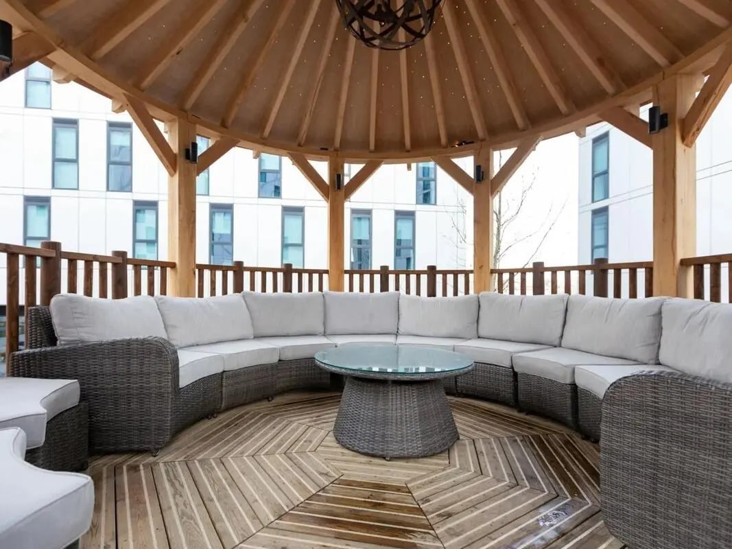 Circular wicker sofa glass table gazebo living room at Pavilion Court London in London Student Accommodation