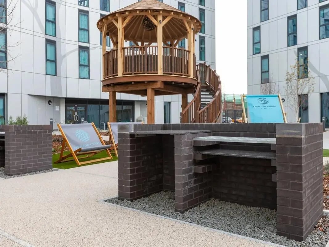 Outdoor barbecue grills with deck chairs exterior at Pavilion Court London in London Student Accommodation