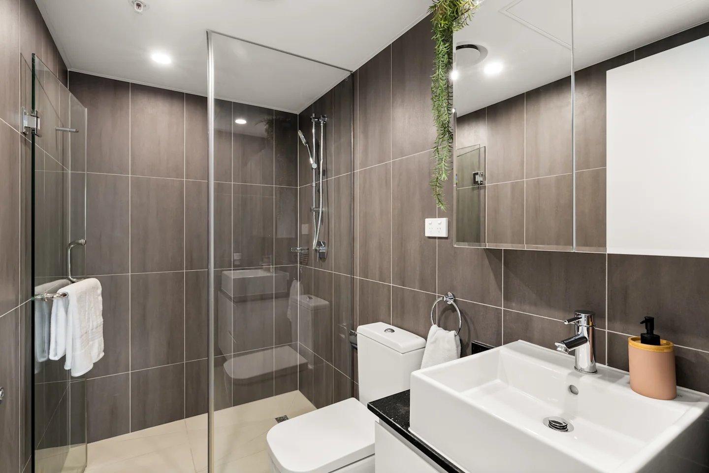 Modern bathroom with shower toilet sink and mirror Bathroom at UKO Parramatta Central in Sydney Student Accommodation