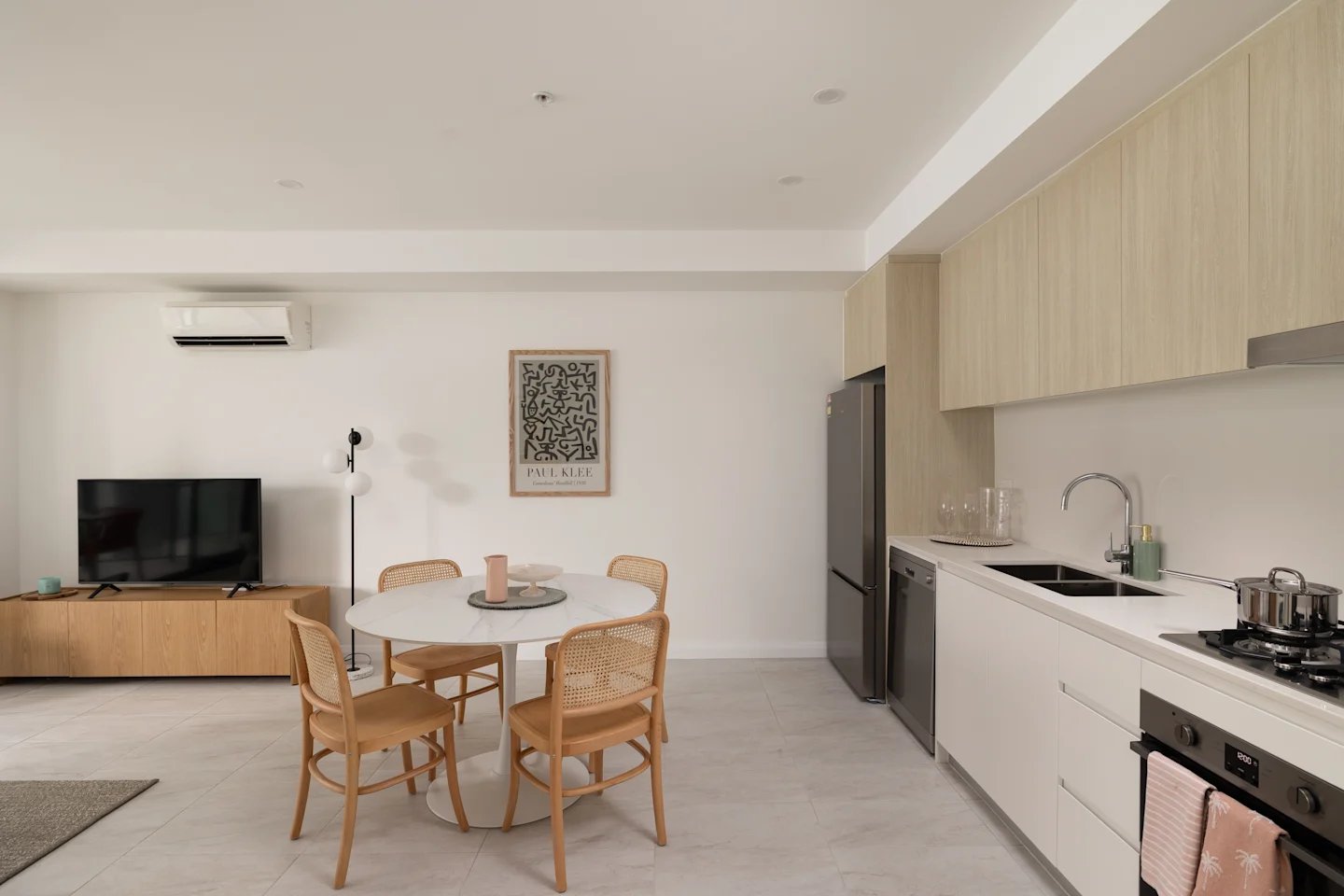Dining table chairs TV kitchen living area exterior at UKO Parramatta Central in Sydney Student Accommodation