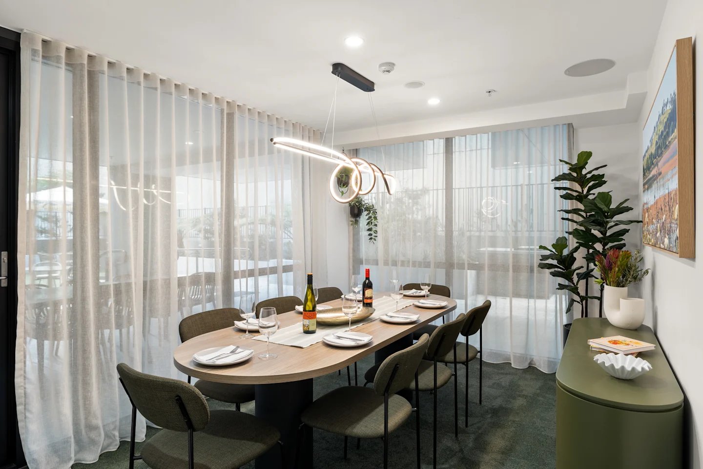 Dining table with chairs bottles plant art dining room at UKO Parramatta Central in Sydney Student Accommodation
